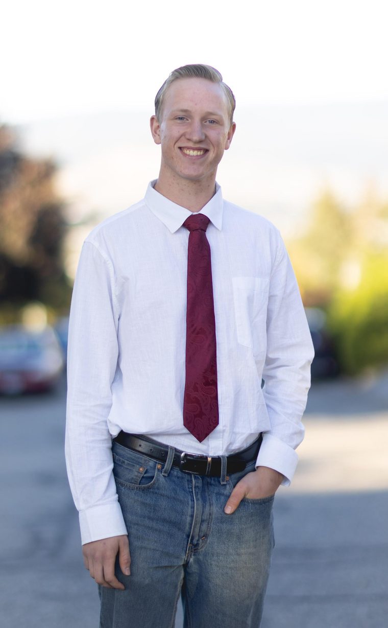 Christopher Moore standing on a residential street, hand in pocket